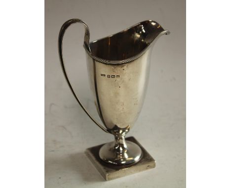 A George V Adam Revival silver helmet shaped cream jug, Birmingham 1912