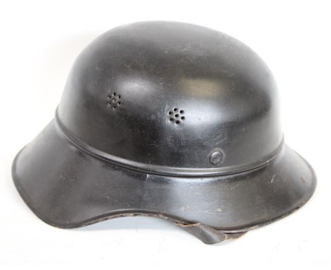 World War II - A Third Reich Nazi German M34 Feuerwehr 'salt shaker' civic stalhelm helmet, leather liner and chinstrap, indi