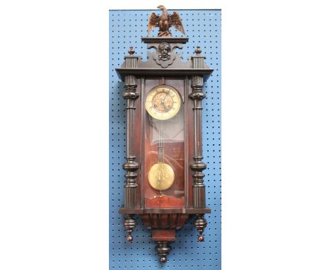 A late 19th century Art Nouveau Vienna time piece, central brass panel, cream chapter ring roman numerals, eagle topped pedim