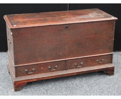 A George III oak mule chest, hinged rectangular top enclosing a vacant interior, above a pair of short drawers, bracket feet,