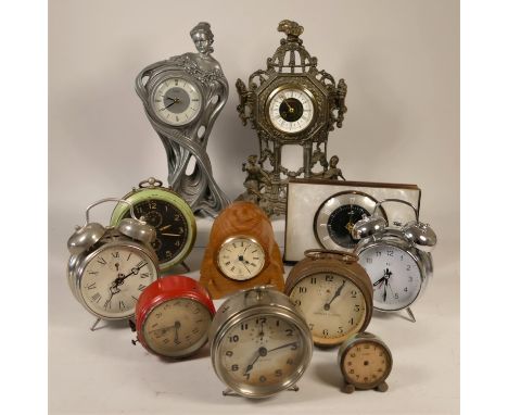 A collection of clocks to include, a barrel shaped quartz clock, a Tam-Tam alarm clock, a gilt metal mantel clock, an Acctim 