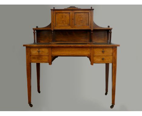 A Victorian rosewood and boxwood inlaid writing desk, with inlaid reticulated gallery panels, the upper cupboard opening to r