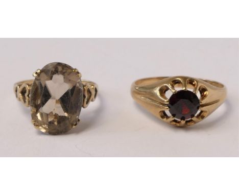 A 9ct gold quartz ring with heart shoulders, L 1/2 and a 9ct gold and garnet ring, R, 4.8gm 