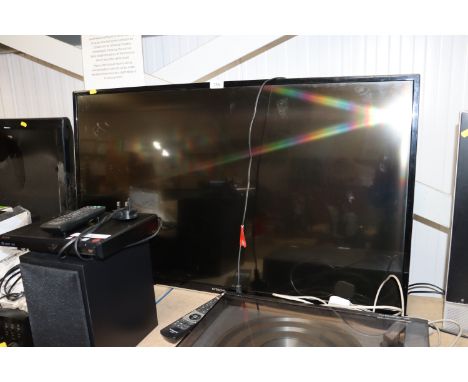A Hitachi smart flat screen television with remote control 