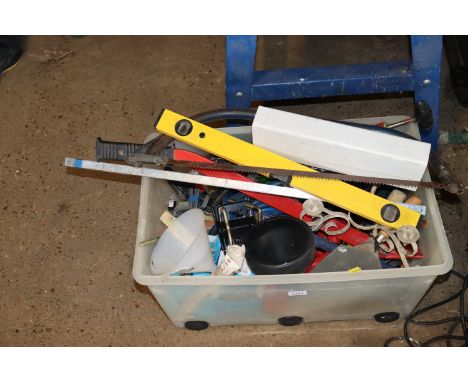 A plastic box containing various hand tools to include bow saw, spirit level, trowel etc.