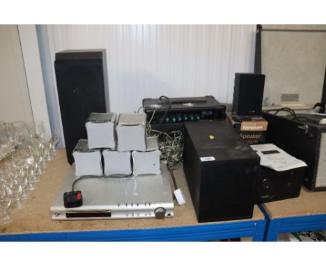 A Boss MG10 guitar amplifier together with a Genexxa surround sound and an S-Master digital amplifier and surround sound set