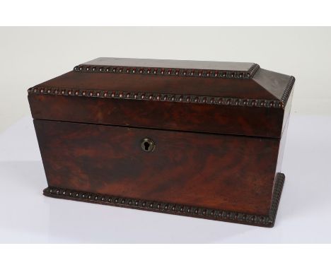 Large George IV mahogany tea caddy, of sarcophagus form with gadrooned rim and Bramah lock, the interior with central glass b