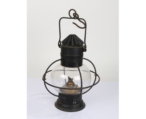 20th Century toleware hanging oil lamp, having pierced chimney above a glass globular body and circular foot, with brass para