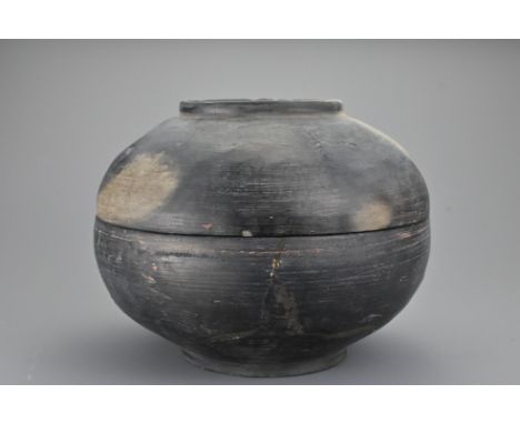 A Chinese Han dynasty (206BC - 22AD) burnished ceramic bowl. Domed bowl and cover each with raised central ring. 16cm height 