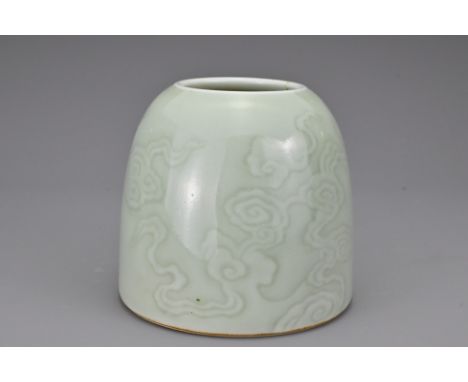 A Chinese celadon-glazed porcelain waterpot. Finely potted with gently rounding shoulders decorated with various ruyi form cl