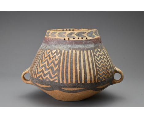 A Chinese Neolithic pot with two small lopped handles to the waist with tapered neck with horizontal lines of perorated holes