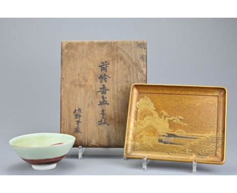 A Japanese gilt lacquer rectangular tray in low relief depicting landscape scene on four L-shaped feet. With fitted wooden bo