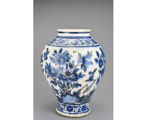 A Persian blue and white ceramic jar decorated with various birds and flowers. Faint reddish pigment noticeable in some flowe