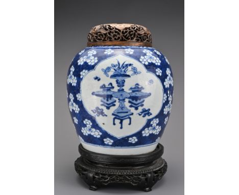 A large Chinese 18th century blue and white porcelain ginger jar. Decorated with various 'treasured objects' and flowers on a