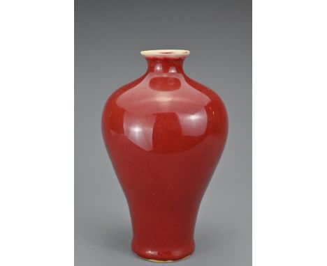 A Chinese Sang-de-Boeuf porcelain vase, Meiping. The finely-potted vase covered in a slightly mottled deep red glaze, thinnin