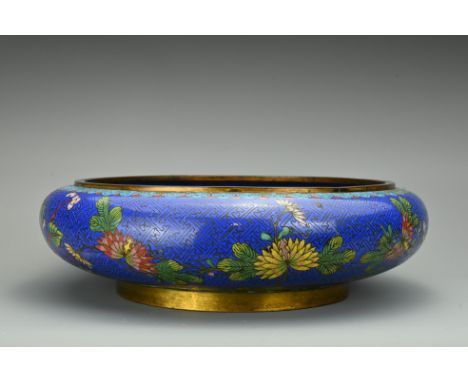A large Chinese 19/20th century cloisonné enamel bowl. Decorated with various flowers and cloud pattern base. 30cm diam. Over