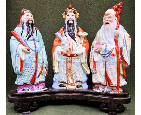 Set of three hand painted and gilded Oriental ceramic figures, upon wooden stand. Approx. 28cms H x 31cms W
reasonable used c