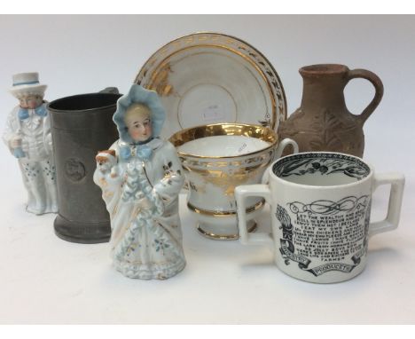 A pair of late 19th Century ceramic nodding figures of a boy and girl together with a continental gilded large cup and saucer