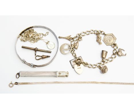 A silver cased manicure set, Birmingham (date letter inscribed) engine turned pattern. A silver charm bracelet and a bar and 