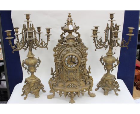 A late 19th Century Garniture clock set comprising an eight day Rococo style mantle clock; a pair of 19th Century Rococo Revi