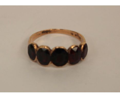 A mid 19th Century rose metal ring, set with five faceted garnets, size K, total gross weight approx 1.8gms