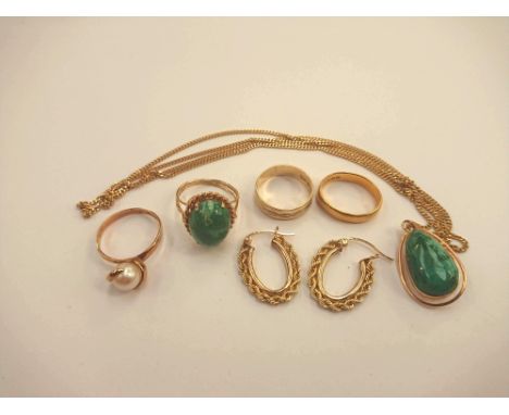 A 14 k gold pendant, set with a pear shaped green hard stone, on a fine link chain, stamped "750" together with a ring set wi