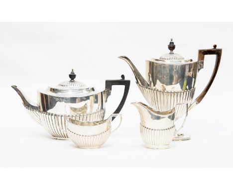 A late Victorian matched silver four piece tea and coffee service in the Georgina manner with gardroon fluted bodies, ebonise