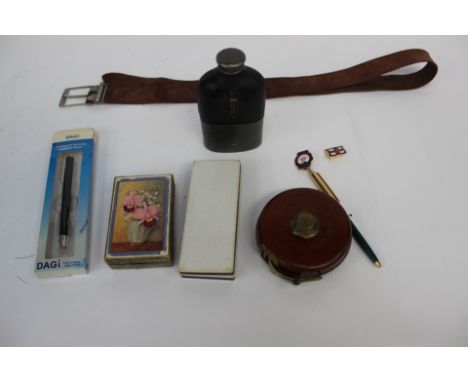 A treble, leather cased retractable tape measure, leather belt, hip flask, map/distance gauge, cards, badges pens