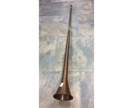 A large copper French hunting horn, 48 1/2 cms long