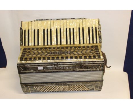 A Hohner Accordion with case