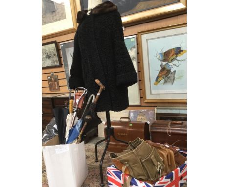 A large collection of vintage textiles, bags, umbrellas, and shoes including; pairs of 1920's two bar shoes, 1930's cuban hee