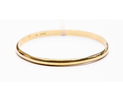 A 9ct gold slave bangle , hallmarked 9ct, round shaped with a diameter 68mm, weight approx  20.3 gms