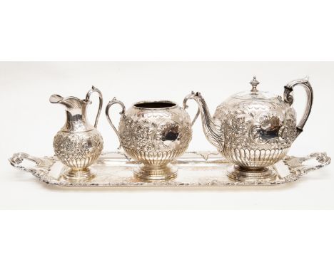 A Victorian style large silver plate tea service including tea pot, sugar bowl, milk jug, and shaped rectangular tray (4)