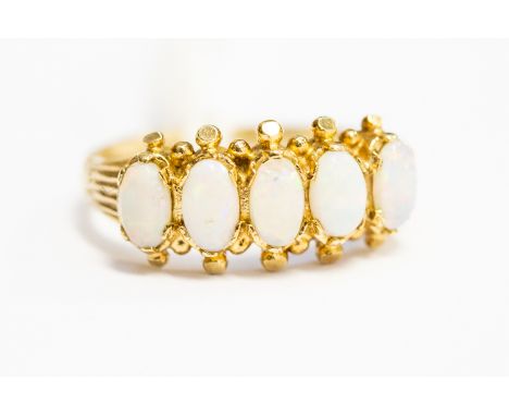 An opal five stone ring, set in  9ct gold, claw set with grain detail, size K 1/2, with a total gross weight approx 2.0 grams