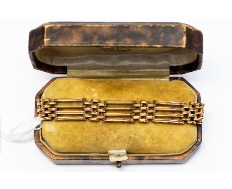 A 9ct gold gate bracelet, four bars, toggle clasp and safety chain, weight approx 22.9 gms
