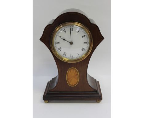 An early 20th Century mahogany balloon shaped mantle clock, having a white enamelled dial and black Roman numerals, the case 