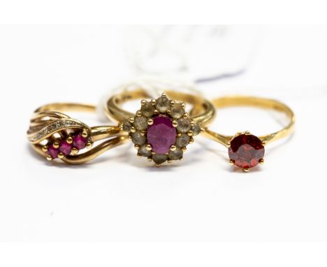 A ruby and diamond cross over dress ring along with a ruby and white stone cluster and a orange stone solitaire,  sizes N and