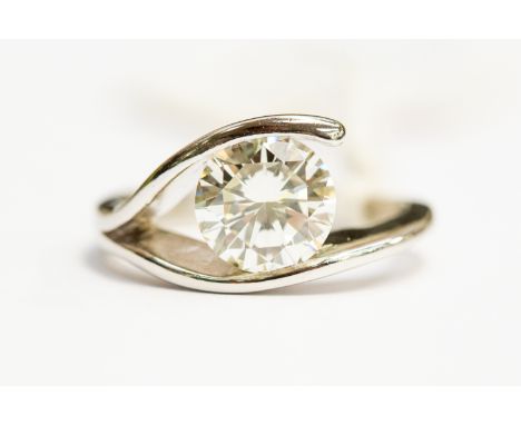 A diamond solitaire, cross over platinum ring, the brilliant cut diamond weighing approx 1.60 carat, assessed colour K, asses