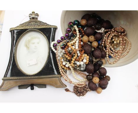 A Studio ceramic raised bowl, with costume jewellery and a photo frame