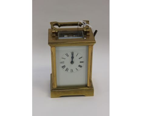 A French brass carriage clock, c.1900, the full enamel dial with Roman numerals to a single train movement and compensated ba