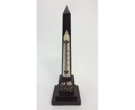 An Ashford marble obelisk thermometer with inlaid flower