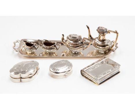 A miniature silver four piece tea service and tray Birmingham, 1982, together with three 0.925 g approx silver pill boxes (8)