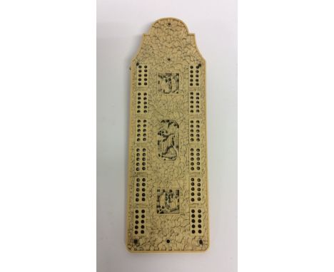 A carved ivory cribbage board