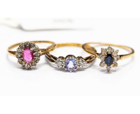 A collection of three 9ct gold ladies dress rings, comprising a sapphire and diamond cluster ring, size Q, a ruby and diamond