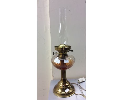 A brass twin burner oil lamp pressed glass reservoir, no shade