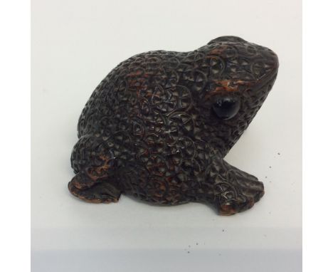A 19th Century carved toad snuff box with sliding base