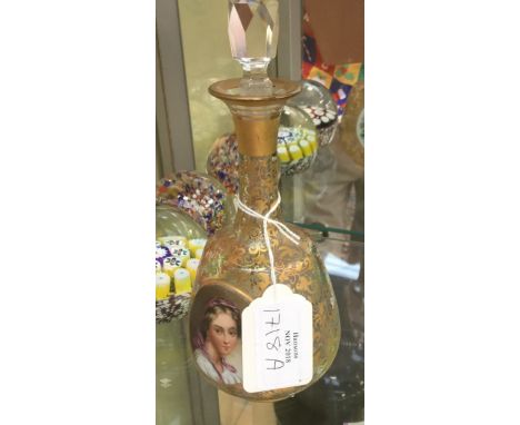  A 19th century Bohemian glass bottle, highlighted in gilt scrolls, the body with opposing oval porcelain panels, one depicti