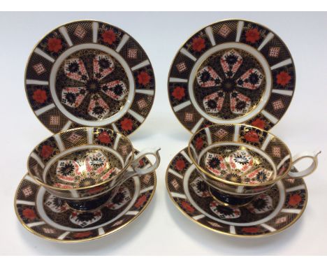 Royal Crown Derby 1128 Imari two tea cups, saucers and side plates, with a 1128 mantle clock (7) 