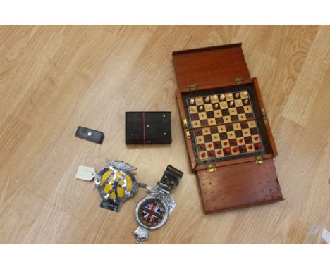  A 19th century music box, a Jaques style folding chess set and collection of vintage automobile badges. (qty)