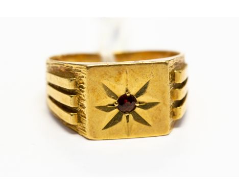 A Gentleman's 18ct gold signet ring star set to the centre with a ruby, size V, total gross weight approx 9.5 gms,